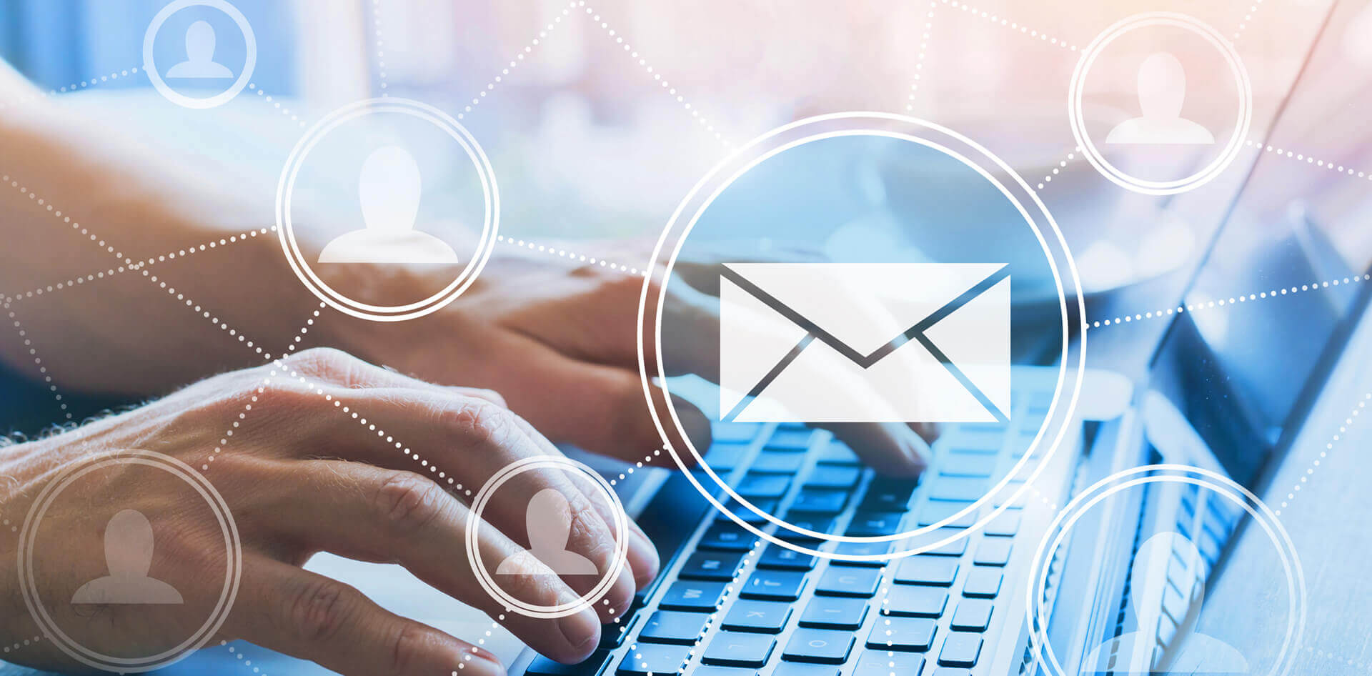 A person typing on a laptop with a mail icon above it