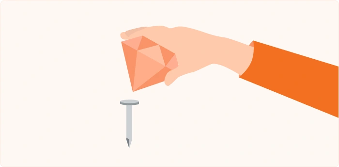 Illustration of a hand using a faceted orange gemstone to hammer a nail.